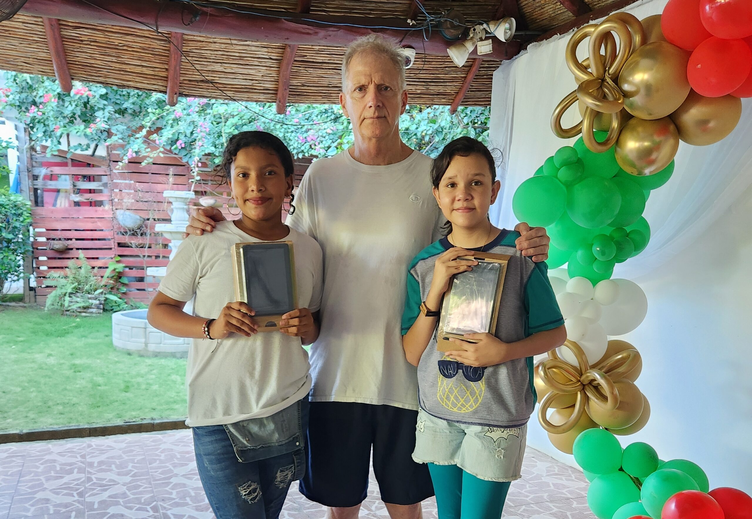 missionary with two nicaraguan children with gifts