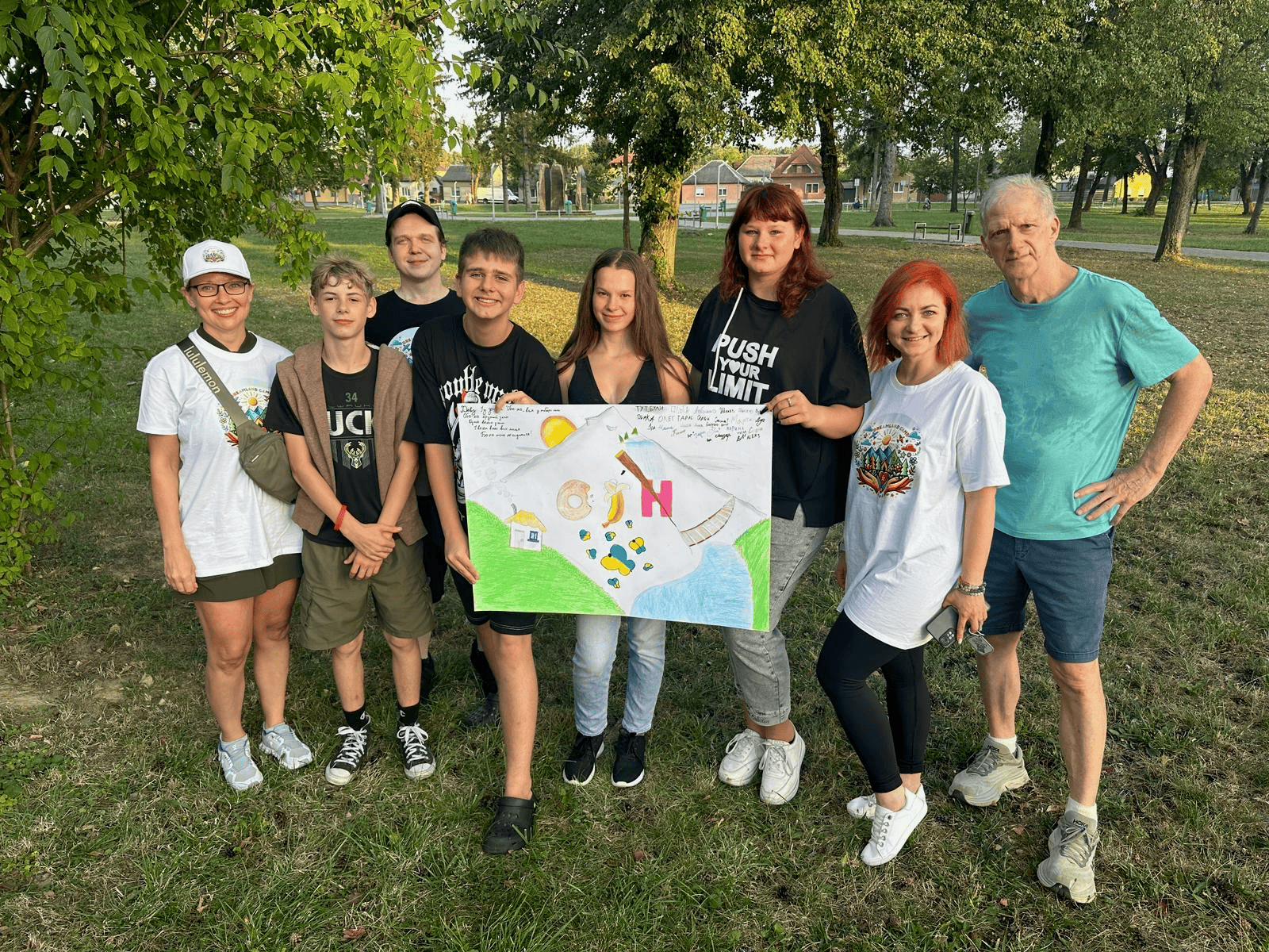 Young Ukrainian boy concentrating on drawing a character with a pencil during a craft session at camp.