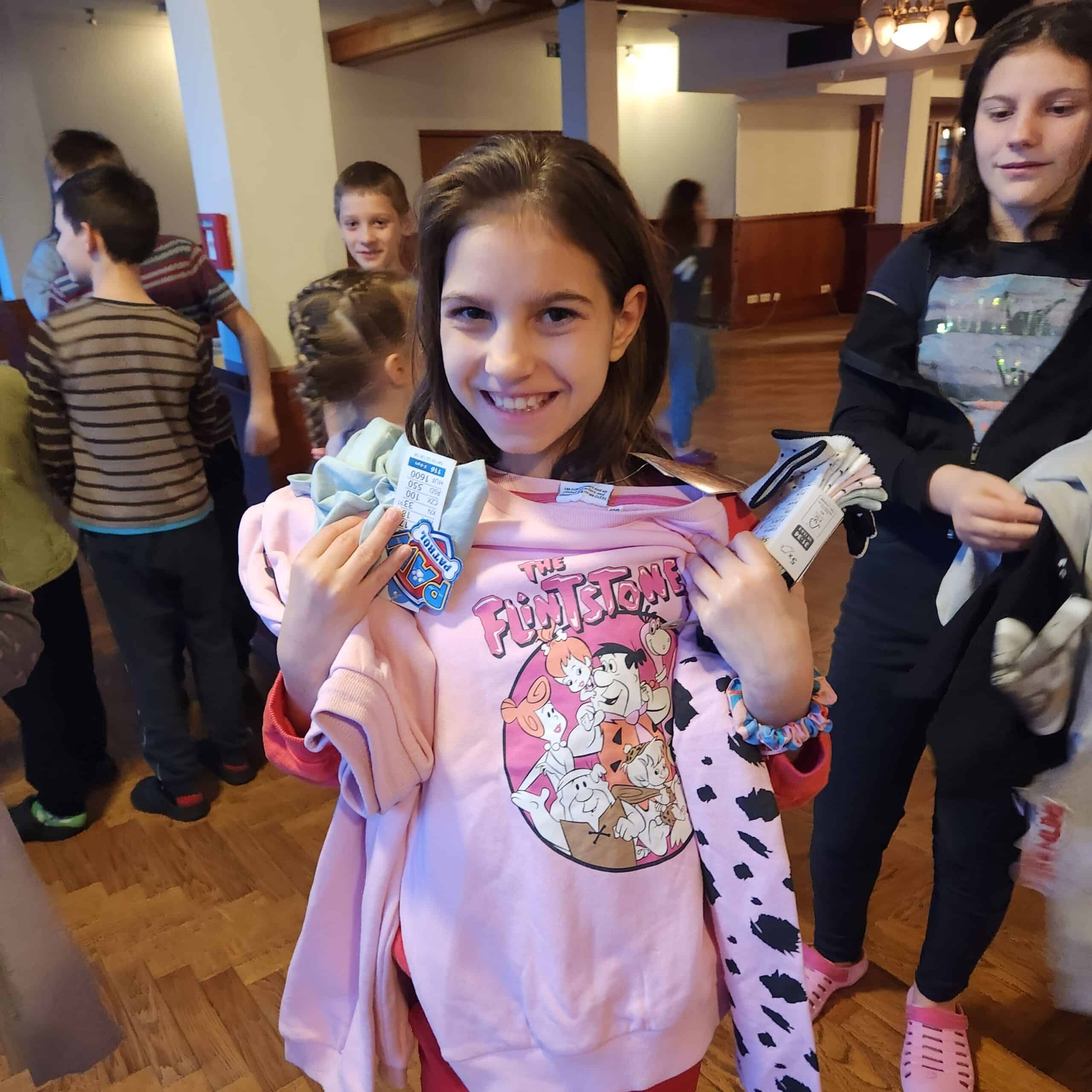 A gentle 6-year-old Ukrainian boy named Oleksandr, looking softly at the camera with a calm, quiet expression. He appears against a simple, brick background.