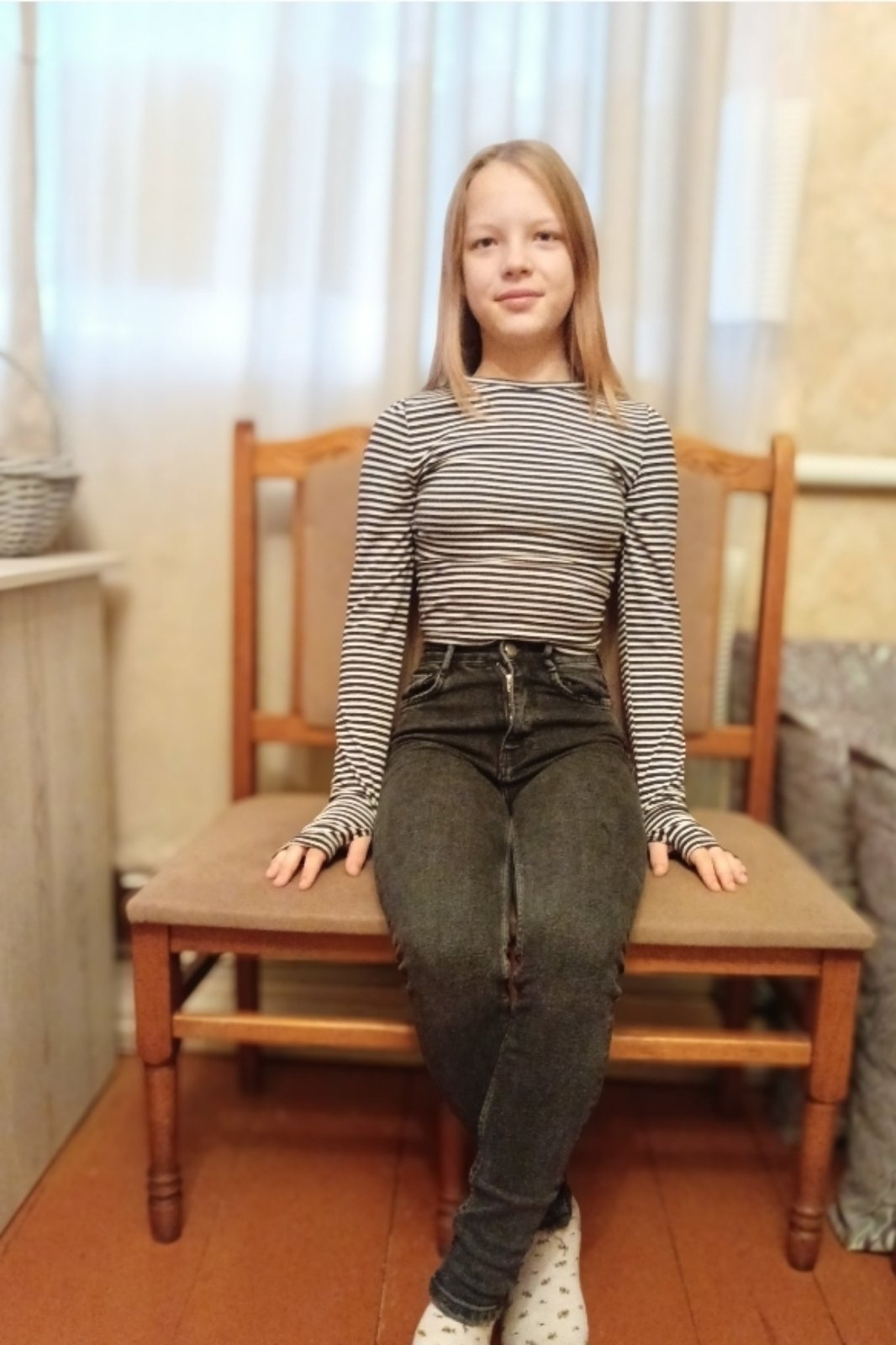 A smiling 11-year-old Ukrainian girl named Daryna, with a kind and confident expression, photographed in natural lighting against a simple background.